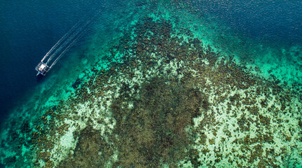Catamaran Sailing Around Shallow Coral Reef In The Ocean In Palawan, Philippines