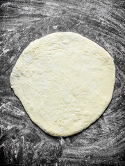 Rolled out pizza dough.