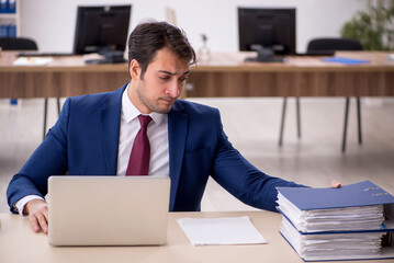 Young male employee working in the office