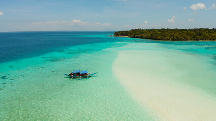 Seascape with a beautiful beach and tropical island surrounded by a coral atoll with turquoise water. Mansalangan sandbar. Summer and travel vacation concept. Balabac, Palawan, Philippines. © Alex Traveler