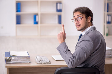 Young male employee working in the office