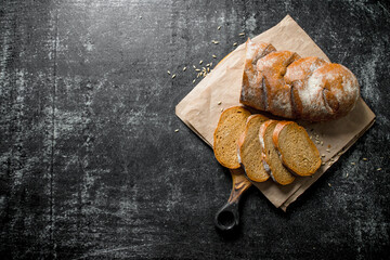 Sliced bread on a cutting Board with paper.