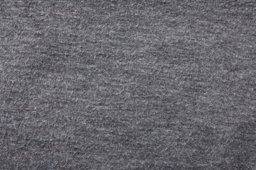 Grey cloth with lint as background, closeup. Before using of fabric shaver