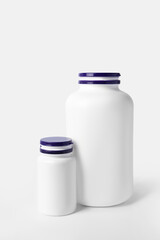 Closed plastic medicine bottles on white background. Medicament