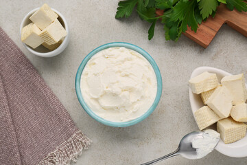 Delicious tofu cheese and spoon on light table, flat lay
