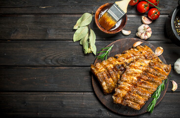 Grilled ribs with sauce, herbs and spices.