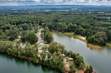 Fototapeta na wymiar Aerial view of beautiful Tims Ford Park RV campground on the lake with the mountain and Winchester Tennessee in the background.