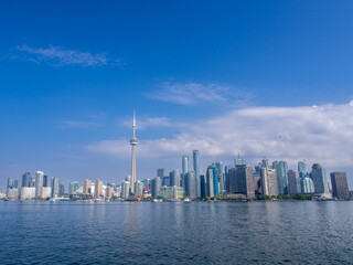 Skyline of Toronto, Canada, with Lake Ontario and closeup of rock in front. with Lake Ontario in front.