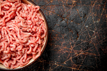 Raw minced beef in bowl .