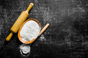 Flour with a ladle and rolling pin.
