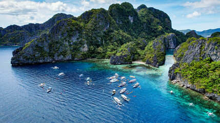 The Big Lagoon In El Nido, Palawan, Philippines. Kayaking In Shallow Crystal Clear Water, Turquoise Colored Reef, Bright Green Tree Covering Cliffs. Pristine landscape