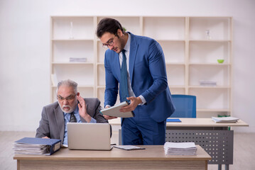 Two male colleagues working in the office