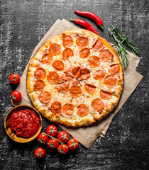 Pepperoni pizza with chili, rosemary and tomatoes.