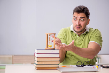 Young male student preparing for exams in the classroom