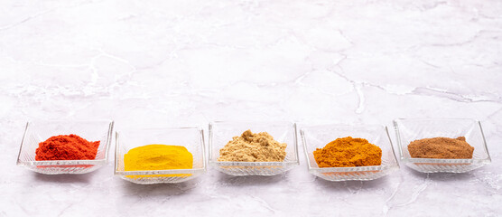 Various dried spices in small bowls