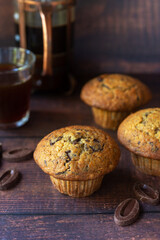 freshly baked homemade banana chocolate chip muffins on wooden table background.