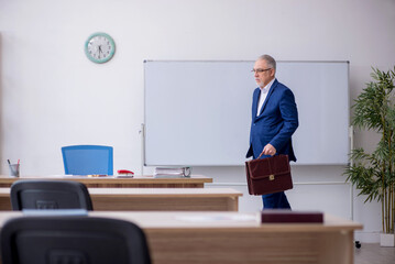 Old male teacher in the classroom
