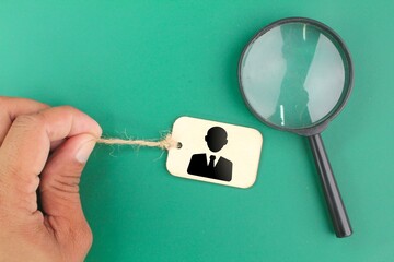 magnifying glass and finger pull worker icon. the concept of finding talent or employees. Human...