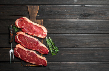 Raw marbled beef steaks.