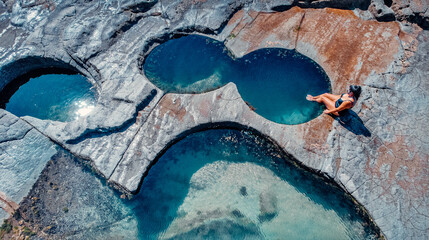 Girl Sitting At Edge of Famous Figure 8 Pool In Royal National Park, Australia
