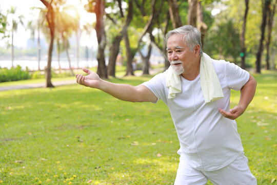 Asian Senior Man Practice Yoga Excercise, Tai Chi Tranining, Stretching And Meditation Together With Relaxation For Healthy In Park Outdoor After Retirement. Happy Elderly Outdoor Lifestyle Concept