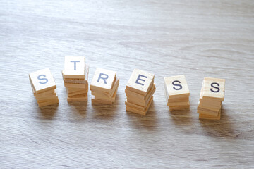 Wooden letters, arrange words, stress on the wooden floor