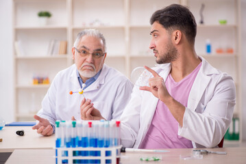 Two male chemists working at the lab