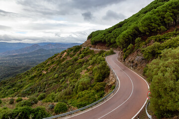 Scenic Highway, Orientale Sarda, in the mountain landscape. Cloudy Rainy Day. Sardinia, Italy.