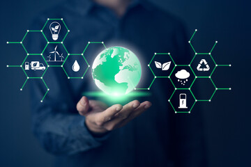 Businessman holding world with economy system icon digital sustainability and Sustainable Technology concept