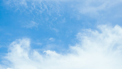 Naklejka na ściany i meble Blue sky background with white clouds for the holidays.