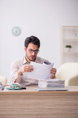 Young male accountant working in the office