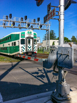 Go Train at a Railway Crossing on a Bright Summer Day