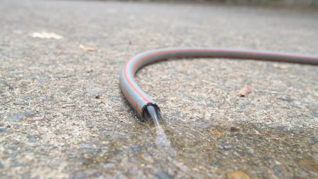 Garden hose with running water close up
