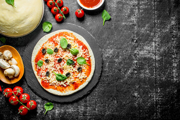 Preparation pizza. Dough with various ingredients for cooking pizza.