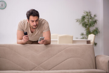 Young man watching tv at home