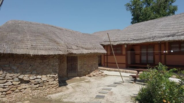 Traditional Korean Thatched Roof House In Nagan Eupseong Folk Village, Suncheon, South Korea. - Pan Right Shot 