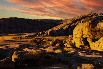 Fototapeta na wymiar Fractured Granite of the Granite Mountains at sunset with red sky in Fremont county Wyoming