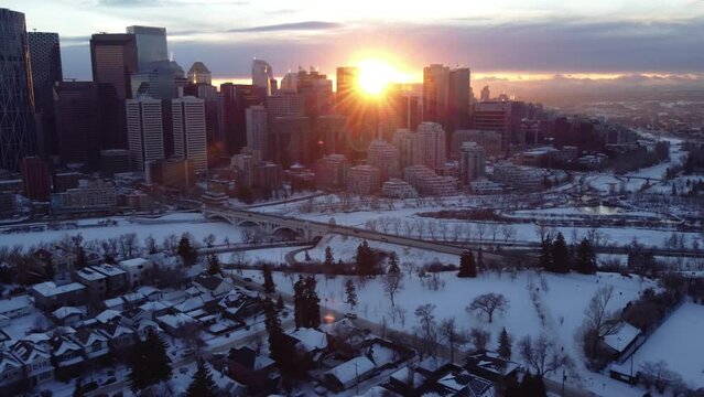 Flying through Calgary's downtown during a winter sunset with a drone