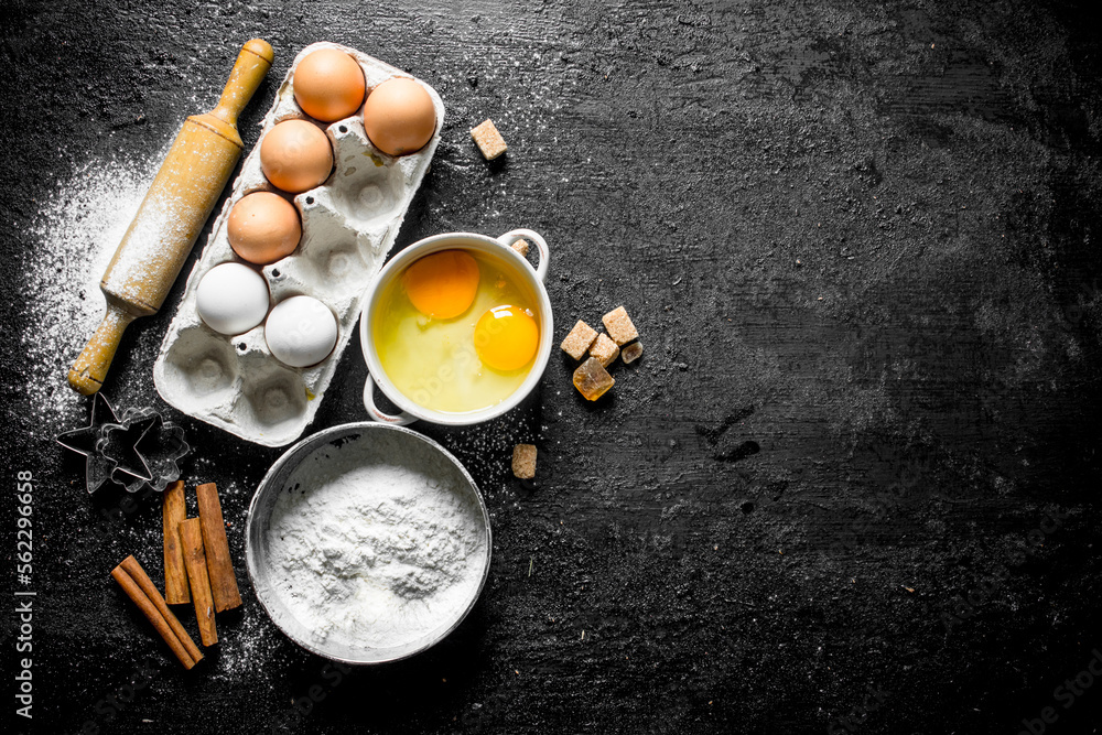 Wall mural Flour with eggs, cinnamon and sugar pieces.