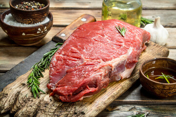 Raw meat. Fresh beef on a cutting Board with herbs and spices.