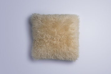 Obraz na płótnie Canvas Fluffy white sheepskin throw pillow
