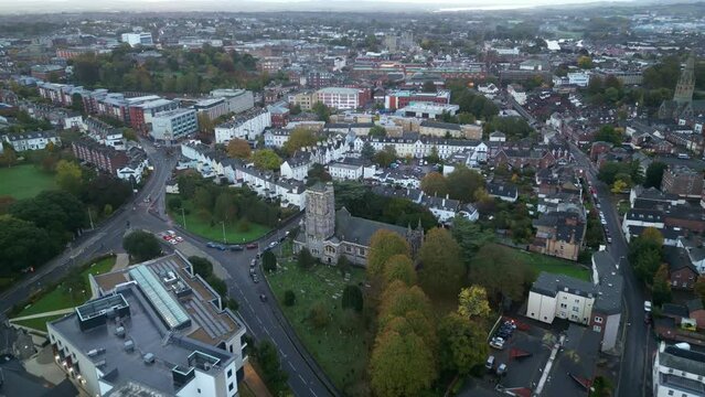Early morning aerial drone flight over Exeter City Centre, Devon, England, UK from St David's Church to Exeter Cathedral