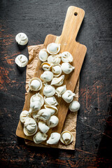 Home raw dumpling on wood cutting Board.