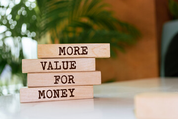 Wooden blocks with words 'More Value for Money'.