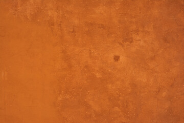 Concrete wall painted orange. Background with the old wall.