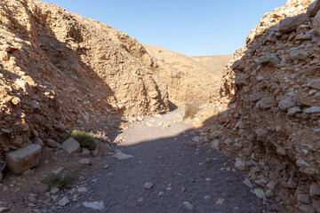 The dried  up river bed - the path to the Red Canyon, in the national reserve - the Red Canyon in the rays of the setting sun, near the city of Eilat, in southern Israel.
