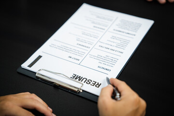 Fototapeta premium Examiner reading a resume during job interview at office Business and human resources concept.