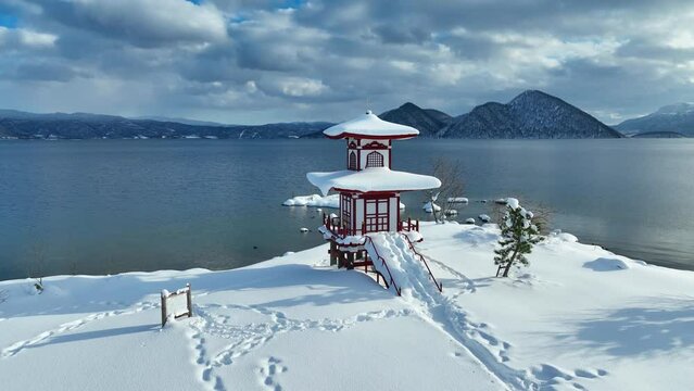 beautiful pagoda in Japan in the snow in winter, zen winter lake in Asia, tourism in Asia in winter, Japanese culture, snowy meditation landscape