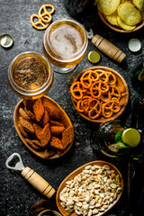 Beer and an assortment of different snacks with openers.