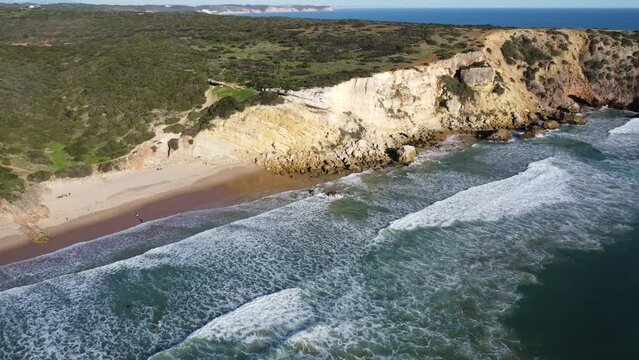 amazing droneshot of zavial beach in algarve portugal at the atlantic ocean, perfect sunny weather